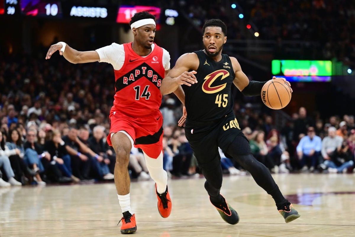May 3, 2026; Cleveland, Ohio, USA; Cleveland Cavaliers guard Donovan Mitchell (45) drives to the basket against Toronto Raptors guard Ja'Kobe Walter (14) during the first half of game seven in the first round of the 2026 NBA Playoffs at Rocket Arena. Mandatory Credit: Ken Blaze-Imagn Images