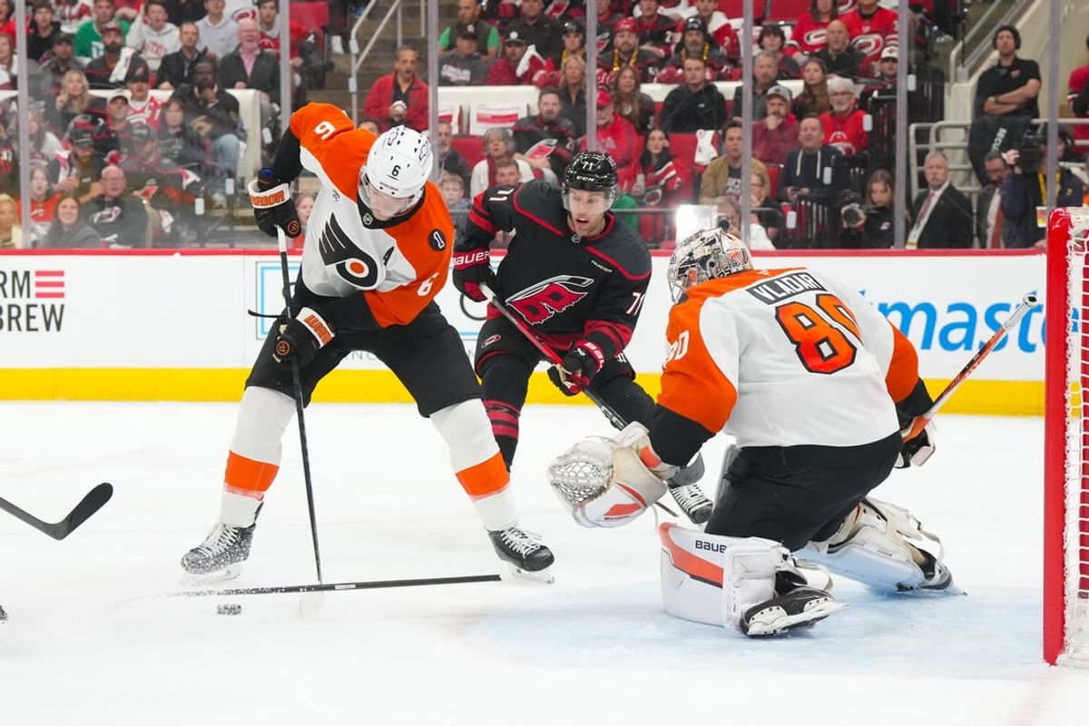 May 4, 2026; Raleigh, North Carolina, USA; Philadelphia Flyers defenseman Travis Sanheim (6) with goaltender Dan Vladar (80) goes to clear the puck away from Carolina Hurricanes left wing Taylor Hall (71) during the first period in game two of the second round of the 2026 Stanley Cup Playoffs at Lenovo Center. Mandatory Credit: James Guillory-Imagn Images