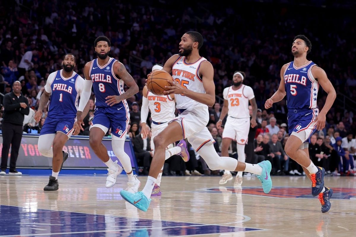 May 4, 2026; New York, New York, USA; New York Knicks guard Mikal Bridges (25) drives to the basket against Philadelphia 76ers center Andre Drummond (1) and forward Paul George (8) and guard Quentin Grimes (5) during the second quarter of game one of the eastern conference semifinal round of the 2026 NBA Playoffs at Madison Square Garden. Mandatory Credit: Brad Penner-Imagn Images