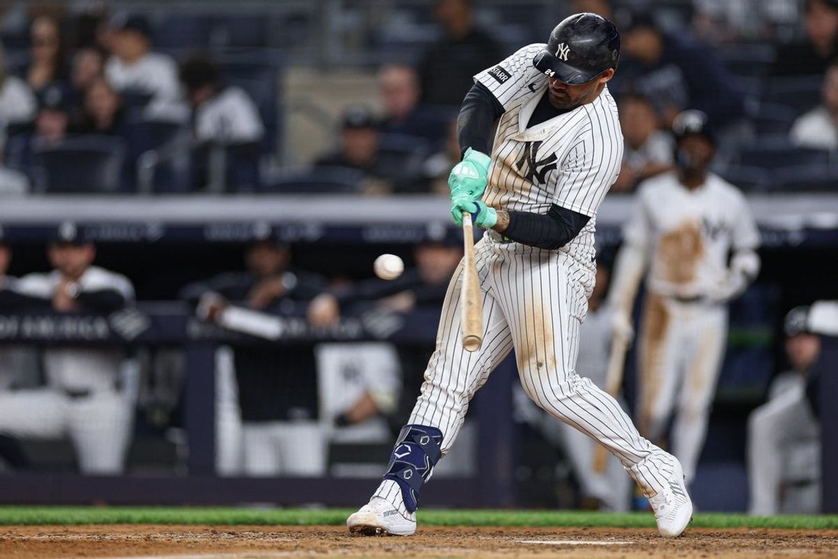 May 4, 2026; Bronx, New York, USA; New York Yankees left fielder Jasson Dominguez (24) hits an RBI single during the eighth inning against the Baltimore Orioles at Yankee Stadium. Mandatory Credit: Vincent Carchietta-Imagn Images