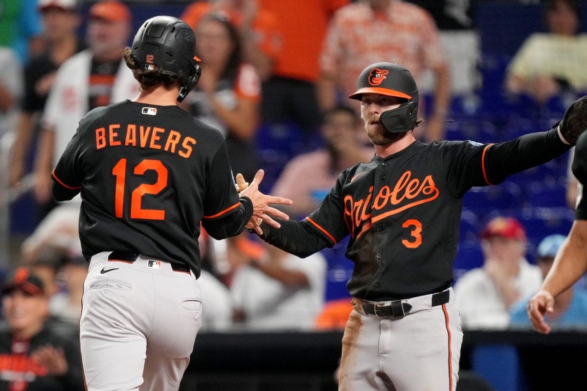 May 5, 2026; Miami, Florida, USA; Baltimore Orioles designated hitter Dylan Beavers (12) and left fielder Taylor Ward (3) celebrate after scoring runs in the first inning against the Miami Marlins at loanDepot Park. Mandatory Credit: Jim Rassol-Imagn Images