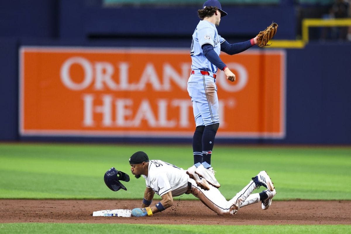 May 5, 2026; St. Petersburg, Florida, USA; Tampa Bay Rays left fielder Chandler Simpson (14) steals second base past Toronto Blue Jays second baseman Ernie Clement (22) in the third inning at Tropicana Field. Mandatory Credit: Nathan Ray Seebeck-Imagn Images