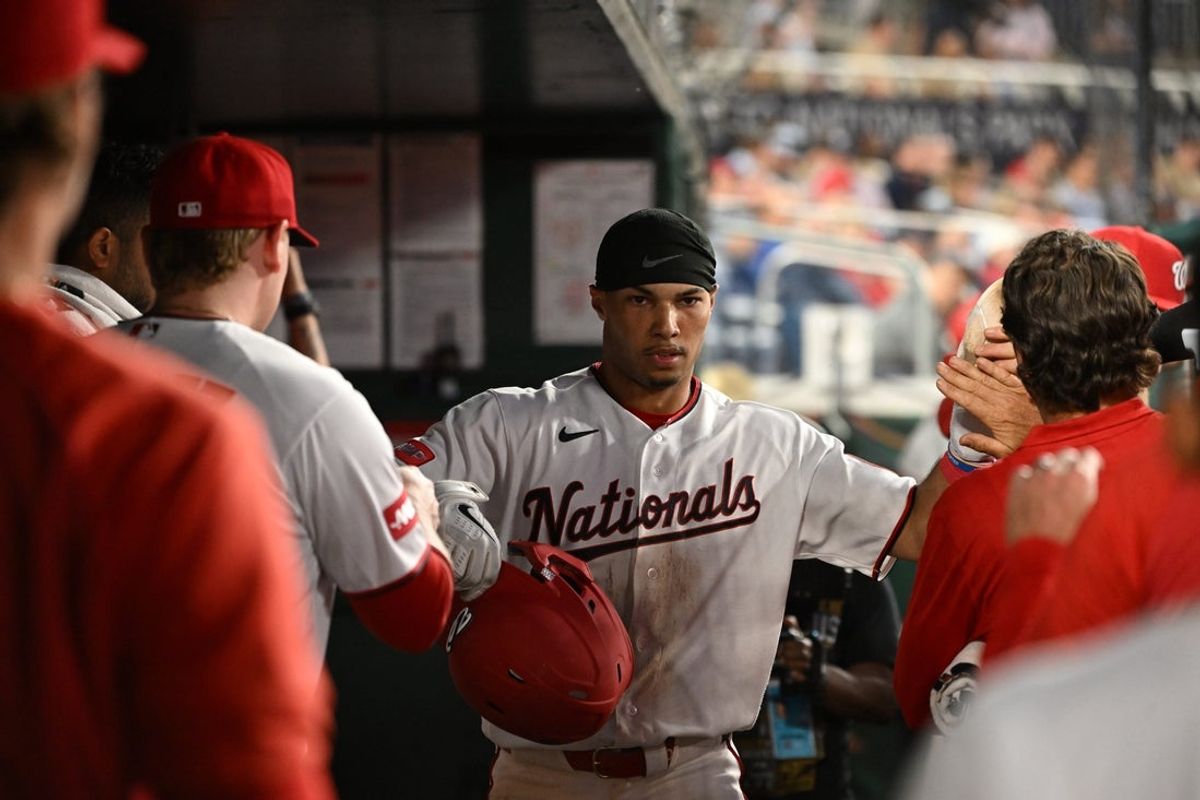 May 5, 2026; Washington, District of Columbia, USA;  Washington Nationals right fielder Daylen Lile (4) celebrates scoring a run in the dugout against the Minnesota Twins during the fifth inning at Nationals Park. Mandatory Credit: Rafael Suanes-Imagn Images