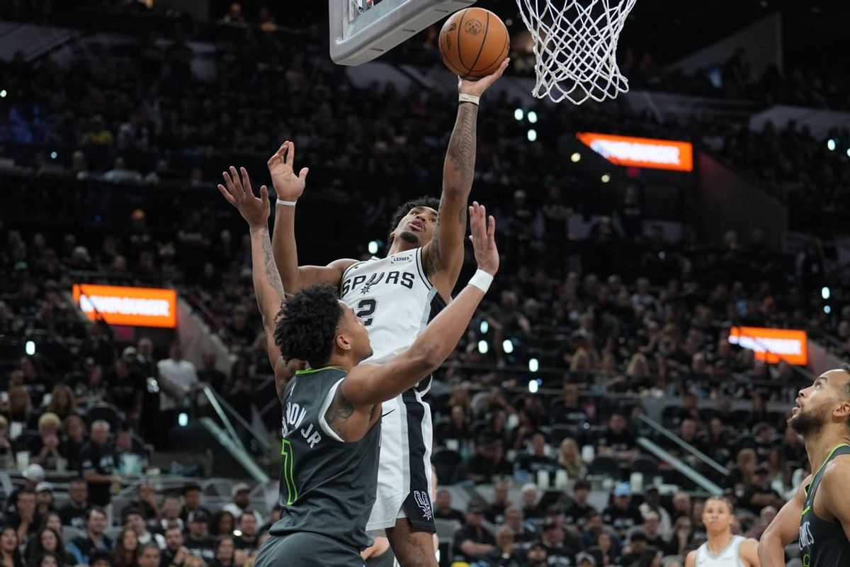 May 6, 2026; San Antonio, Texas, USA; San Antonio Spurs guard Dylan Harper (2) shoots over Minnesota Timberwolves guard Terrence Shannon Jr. (1) in the second half during game two of the second round of the 2026 NBA Playoffs at Frost Bank Center. Mandatory Credit: Daniel Dunn-Imagn Images