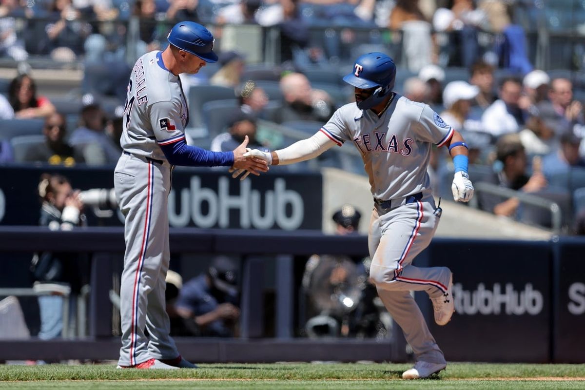 May 7, 2026; Bronx, New York, USA; Texas Rangers left fielder Ezequiel Duran (20) high fives Texas Rangers third base coach Corey Ragsdale (64) as he rounds the bases after hitting a solo home run against the New York Yankees during the third inning at Yankee Stadium. Mandatory Credit: Brad Penner-Imagn Images