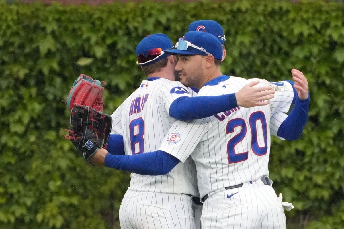 May 7, 2026; Chicago, Illinois, USA; Chicago Cubs right fielder Michael Conforto (20) celebrates the Cubs win  against the Cincinnati Reds with left fielder Ian Happ (8) at Wrigley Field. Mandatory Credit: David Banks-Imagn Images