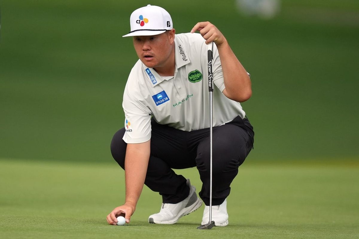 May 7, 2026; Charlotte, North Carolina, USA; Sungjae Im sets his ball on the fifth green during the first round of the Truist Championship golf tournament. Mandatory Credit: Jim Dedmon-Imagn Images