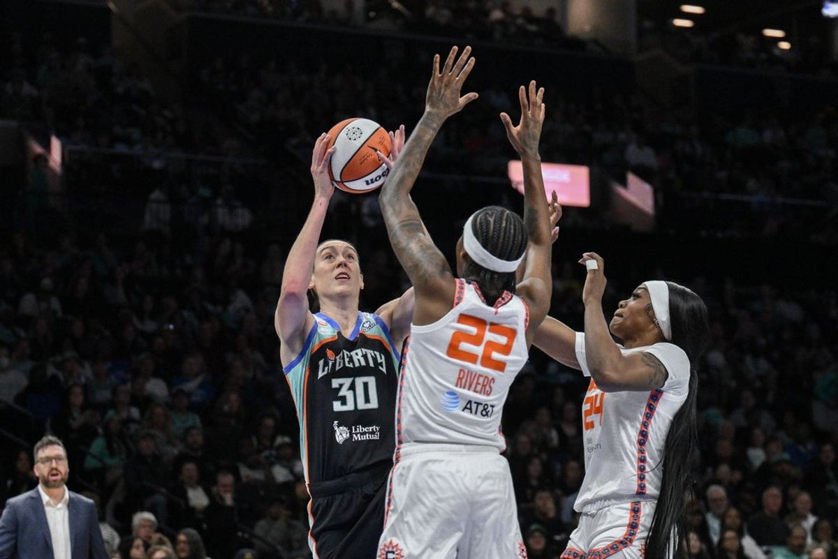May 8, 2026; Brooklyn, New York, USA; New York Liberty forward Breanna Stewart (30) shoots against Connecticut Sun guard Saniya Rivers (22) and forward Aneesah Morrow (24) during the first half at Barclays Center. Mandatory Credit: John Jones-Imagn Images