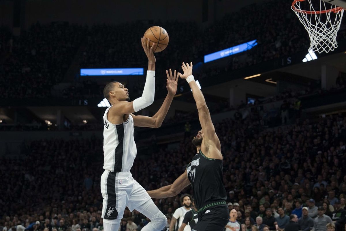 May 8, 2026; Minneapolis, Minnesota, USA; San Antonio Spurs forward Victor Wembanyama (1) shoots against Minnesota Timberwolves center Rudy Gobert (27) in the first half during game three of the second round of the 2026 NBA Playoffs at Target Center. Mandatory Credit: Jesse Johnson-Imagn Images