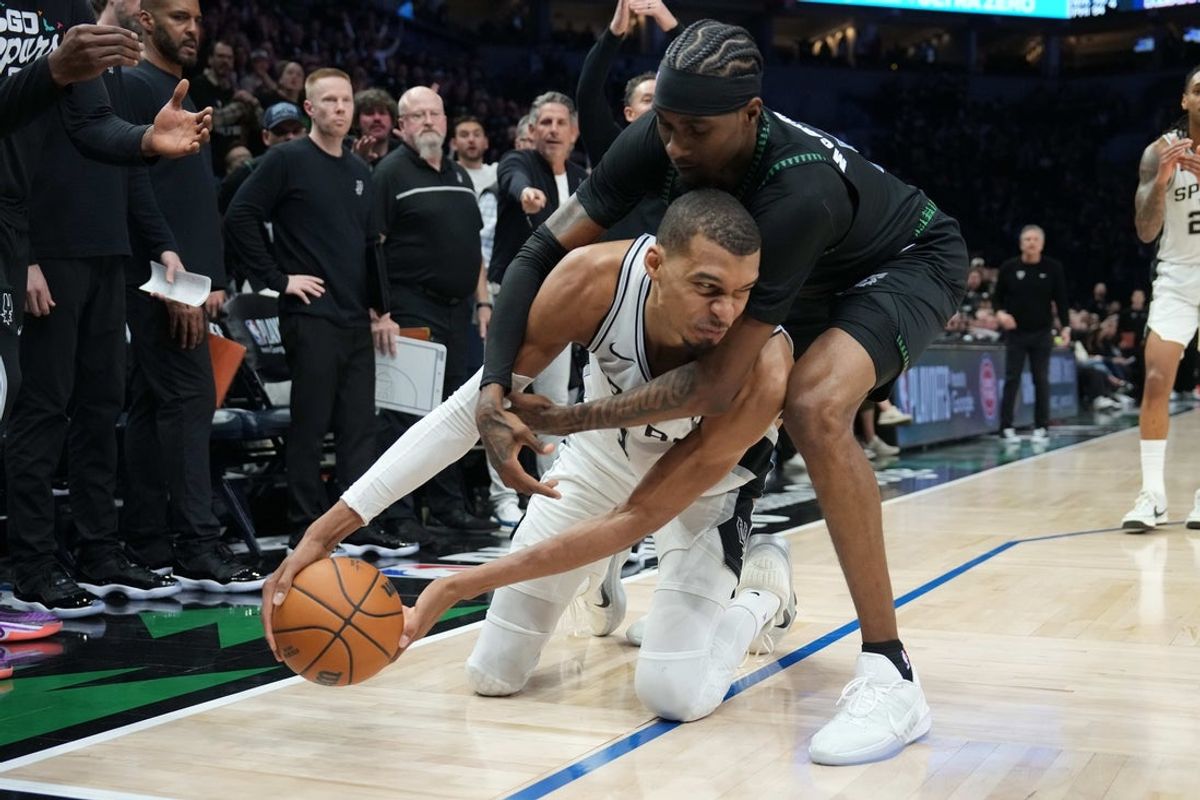 May 8, 2026; Minneapolis, Minnesota, USA; San Antonio Spurs forward Victor Wembanyama (1) tries to keep the ball away from Minnesota Timberwolves forward Jaden McDaniels (3) in the second half during game three of the second round of the 2026 NBA Playoffs at Target Center. Mandatory Credit: Jesse Johnson-Imagn Images