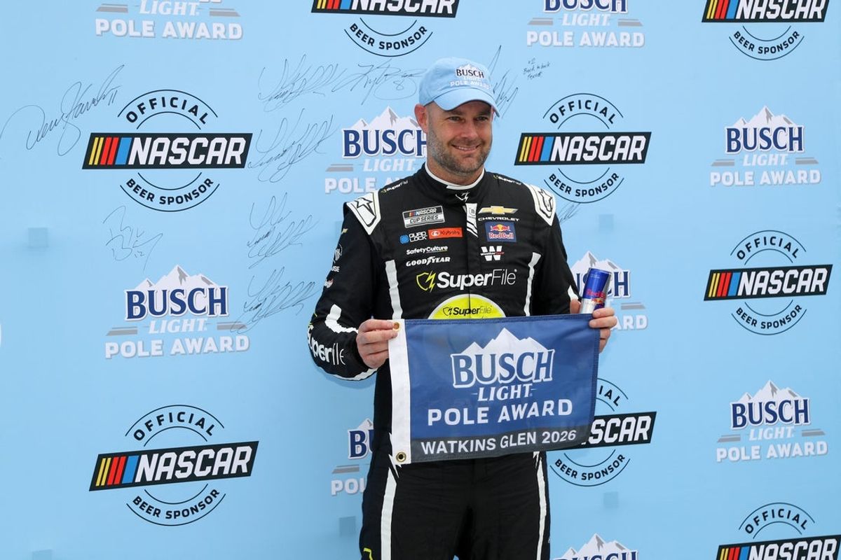 May 9, 2026; Watkins Glen, New York, USA; NASCAR Cup Series driver Shane Van Gisbergen stands with the Busch Light Pole Award after winning the pole for the Go Bowling at The Glen at Watkins Glen International. Mandatory Credit: Matthew O'Haren-Imagn Images