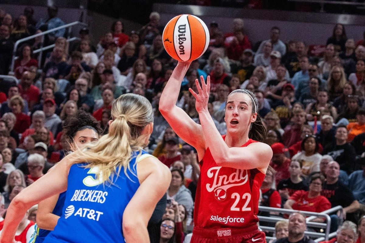 May 9, 2026; Indianapolis, Indiana, USA; Indiana Fever guard Caitlin Clark (22) passes the ball while Dallas Wings guard Paige Bueckers (5) defends in the first half at Gainbridge Fieldhouse. Mandatory Credit: Trevor Ruszkowski-Imagn Images