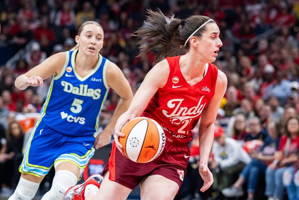 May 9, 2026; Indianapolis, Indiana, USA; Indiana Fever guard Caitlin Clark (22) dribbles the ball while Dallas Wings guard Paige Bueckers (5) defends in the first half at Gainbridge Fieldhouse. Mandatory Credit: Trevor Ruszkowski-Imagn Images