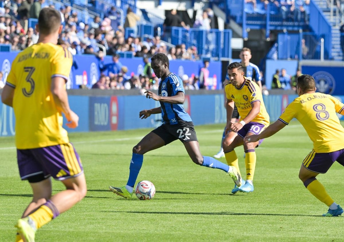 May 9, 2026; Montreal, Province of Quebec, CAN; CF Montreal midfielder Victor Loturi (22) plays the ball and Orlando City SC defender Adrian Marin (3) defends with teammate midfielder Braian Ojeda (8) during the first half at Saputo Stadium. Mandatory Credit: Eric Bolte-Imagn Images