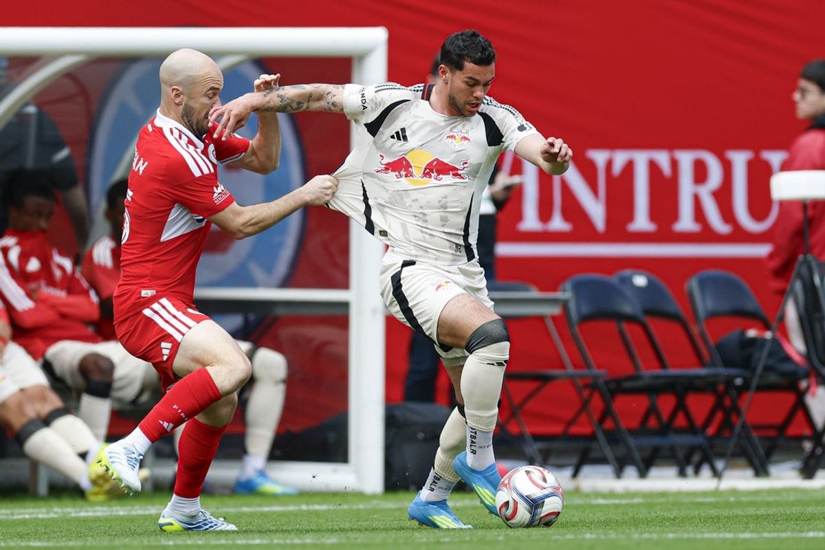 May 9, 2026; Chicago, Illinois, USA; Chicago Fire FC defender Andrew Gutman (15) defends against Red Bull New York forward Cade Cowell (7) during the first half at Soldier Field. Mandatory Credit: Kamil Krzaczynski-Imagn Images