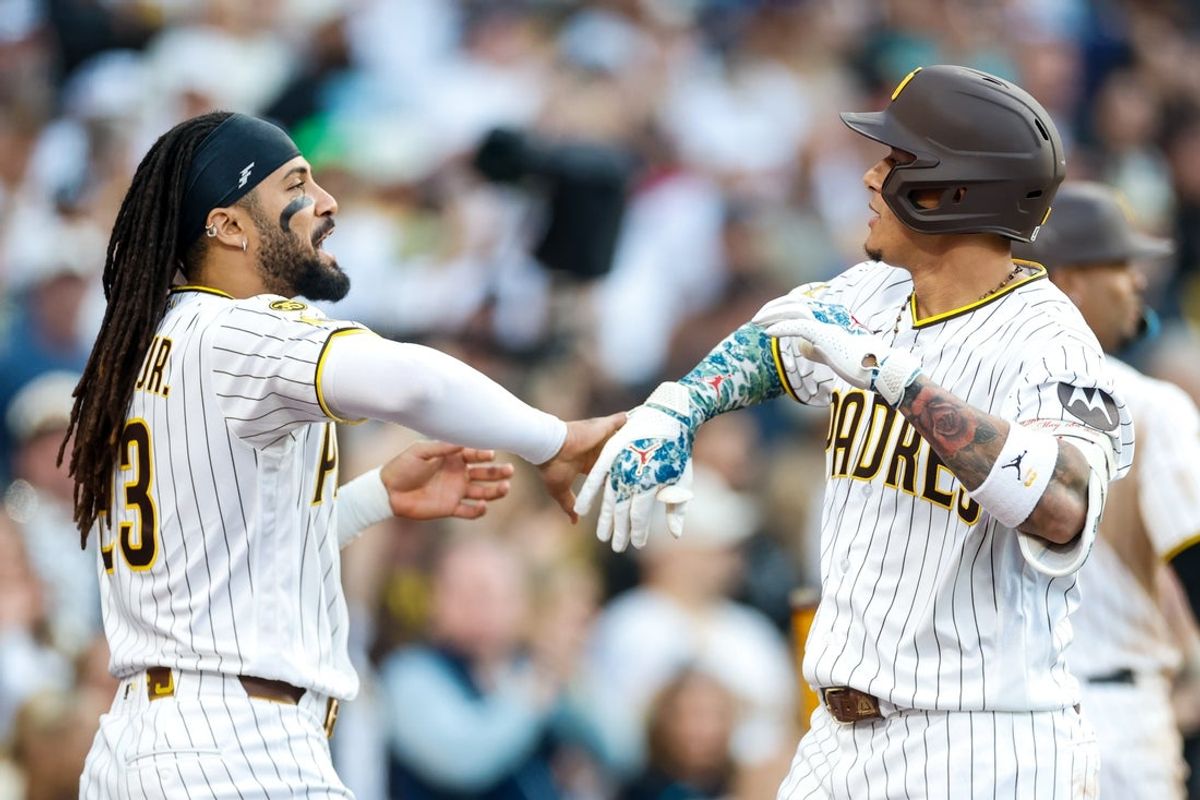 May 9, 2026; San Diego, California, USA; San Diego Padres third baseman Manny Machado (13) celebrates with  right fielder Fernando Tatis Jr. (23) after hitting a one run home run during the eighth inning against the St. Louis Cardinals  at Petco Park. Mandatory Credit: David Frerker-Imagn Images
