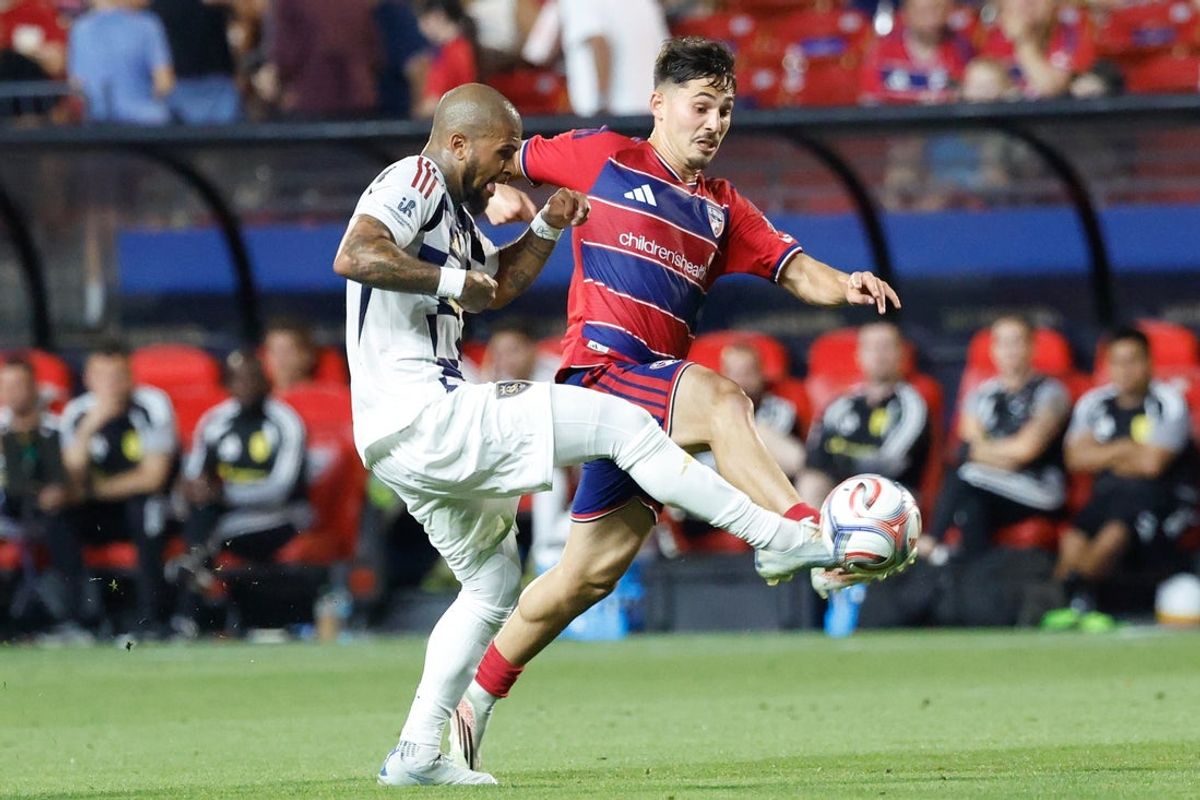 May 9, 2026; Frisco, Texas, USA;  FC Dallas midfielder Ran Binyamin (6) and Real Salt Lake defender DeAndre Yedlin (2) reach for the ball during the second half at Toyota Stadium. Mandatory Credit: Chris Jones-Imagn Images