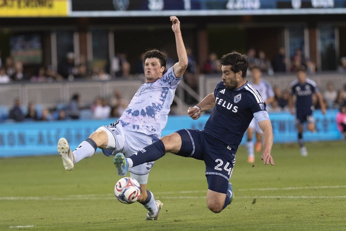 May 9, 2026; San Jose, California, USA;  San Jose Earthquakes defender Daniel Munie (5) and Vancouver Whitecaps FC forward Brian White (24) battle for the ball during the first half at PayPal Park. Mandatory Credit: Stan Szeto-Imagn Images