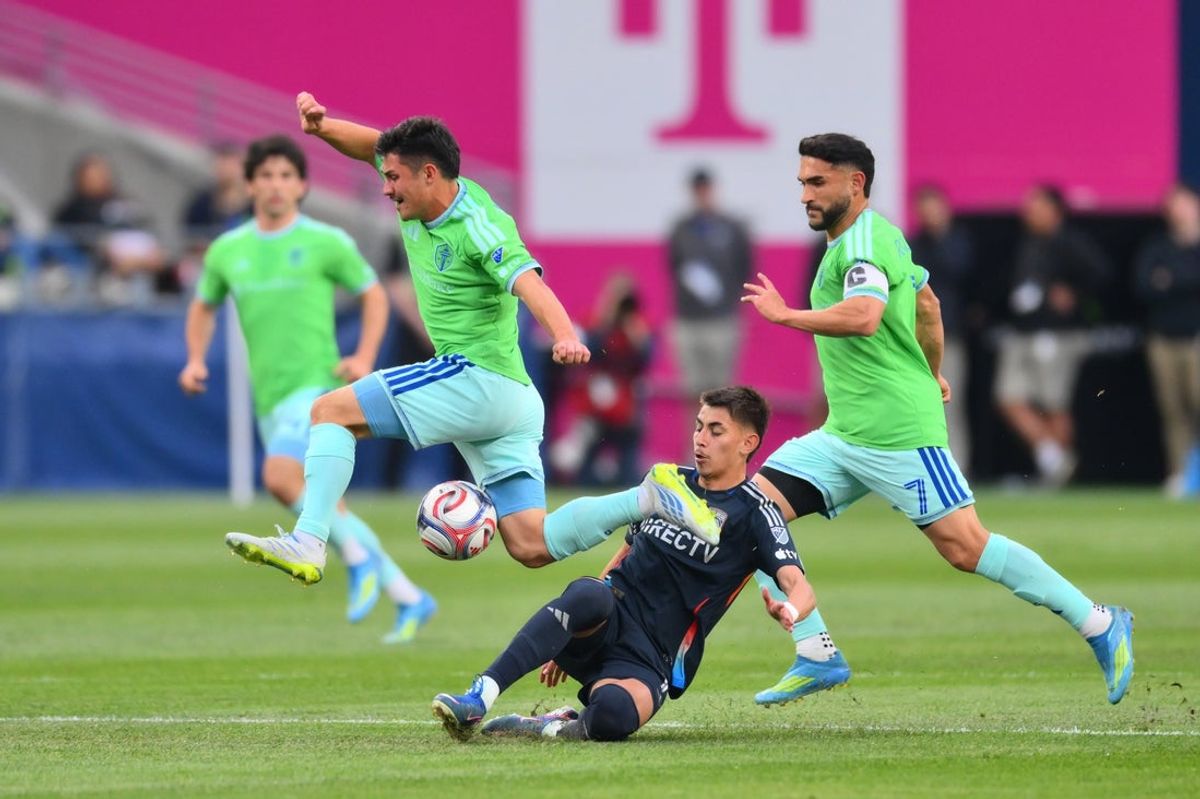 May 9, 2026; Seattle, Washington, USA; Seattle Sounders FC midfielder Kalani Kossa-Rienzi (85) avoids the slide tackle by San Diego FC midfielder David Vazquez (19) during the first half at Lumen Field. Mandatory Credit: Steven Bisig-Imagn Images