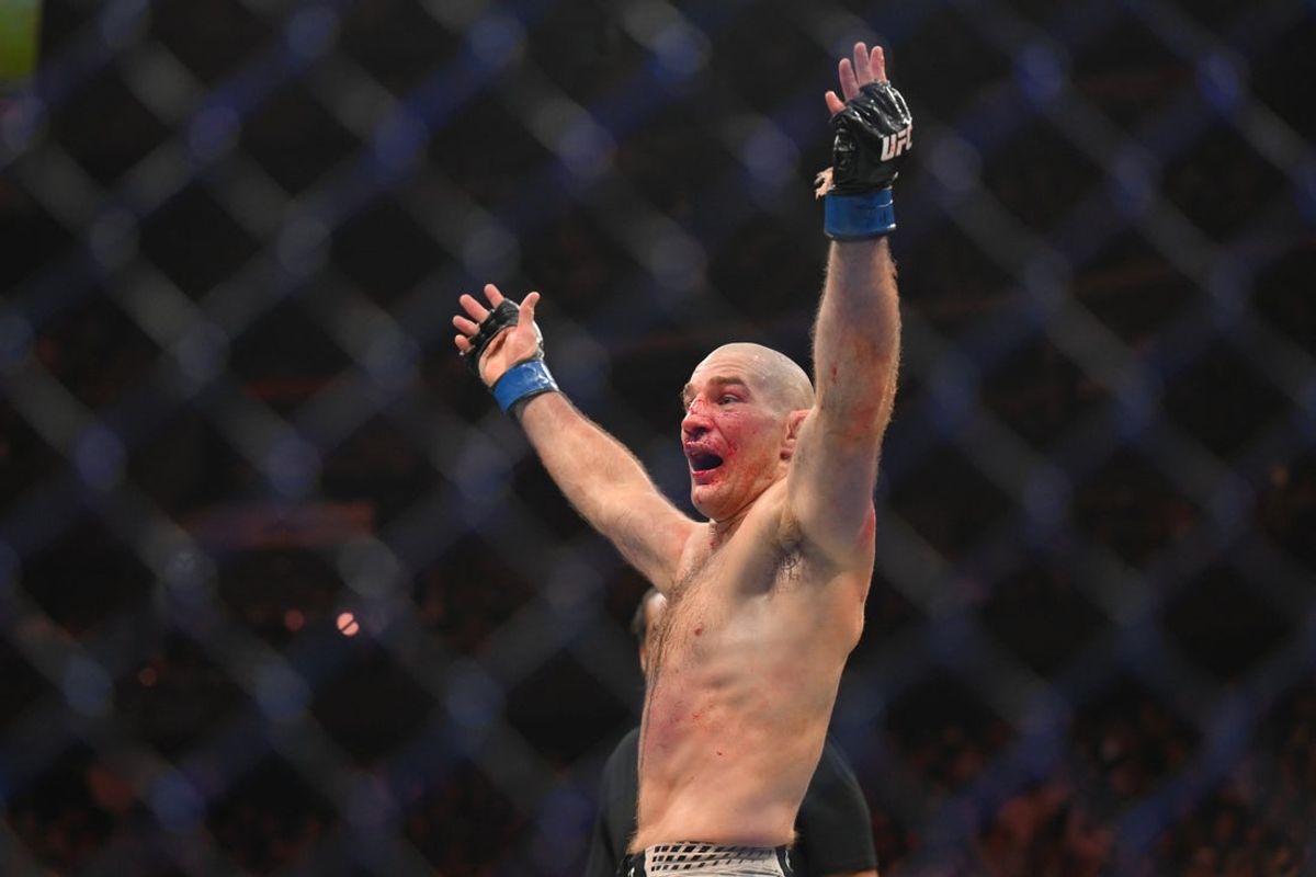 May 9, 2026; Newark, New Jersey, UNITED STATES; Sean Strickland (blue gloves) celebrates after defeating Khamzat Chimaev (red gloves) during UFC 328 at Prudential Center. Mandatory Credit: John Jones-Imagn Images