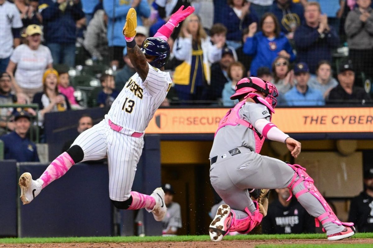 May 10, 2026; Milwaukee, Wisconsin, USA;  Milwaukee Brewers third baseman Luis Rengifo (13) scores a run past New York Yankees catcher J.C. Escarra (25) in the fourth inning at American Family Field. Mandatory Credit: Benny Sieu-Imagn Images