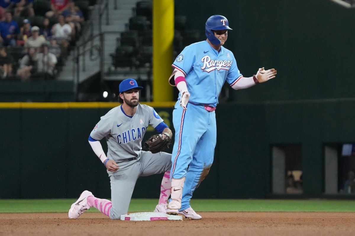 May 10, 2026; Arlington, Texas, USA;  Texas Rangers first baseman Joc Pederson (3) reacts after hitting an RBI double during the fourth inning as Chicago Cubs shortstop Dansby Swanson (7) looks on at Globe Life Field. Mandatory Credit: Raymond Carlin III-Imagn Images
