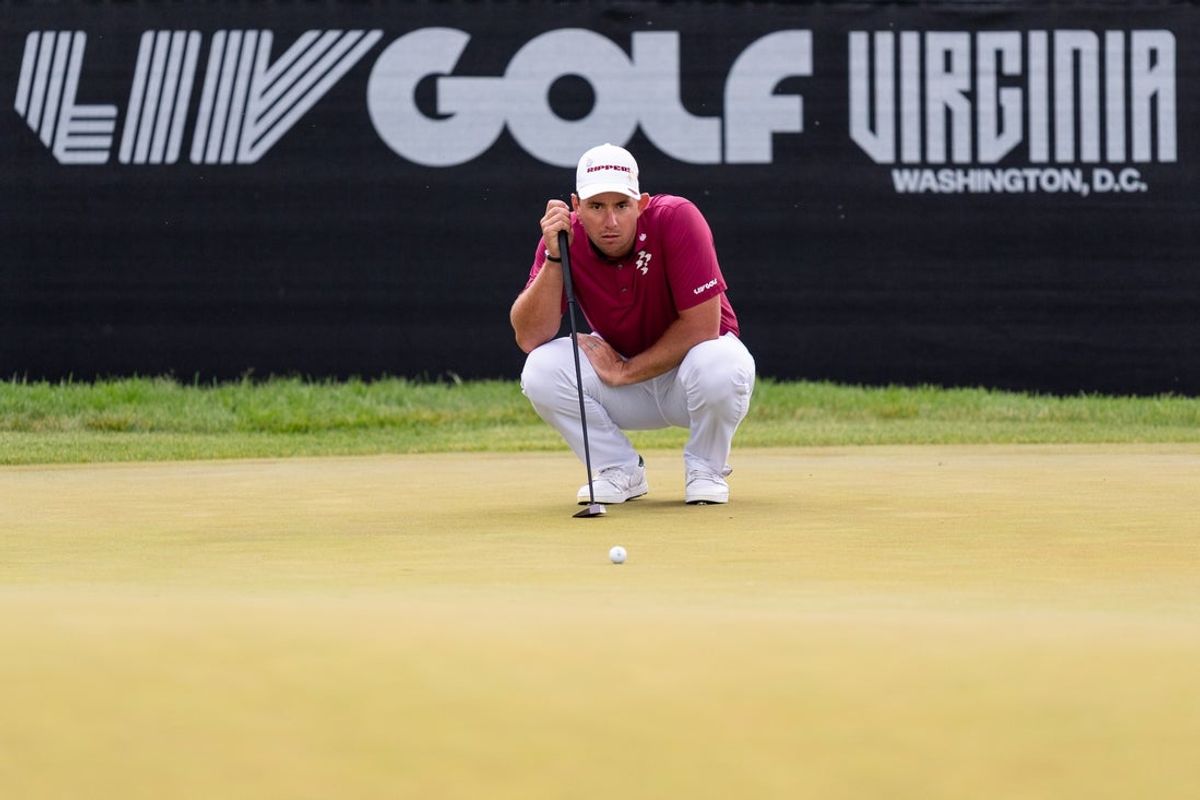 May 10, 2026; Sterling, Virginia, USA; Lucas Herbert lines up his final putt during the final round of LIV Golf Virginia golf tournament at Trump National Golf Club. Mandatory Credit: Jack Power-Imagn Images