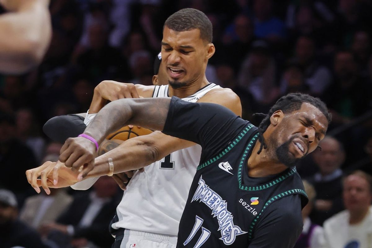 May 10, 2026; Minneapolis, Minnesota, USA; San Antonio Spurs center Victor Wembanyama (1) commits a level two flagrant foul against Minnesota Timberwolves center Naz Reid (11) in the second quarter of game four of the second round of the 2026 NBA Playoffs at Target Center. Wembanyama had to leave the game. Mandatory Credit: Bruce Kluckhohn-Imagn Images