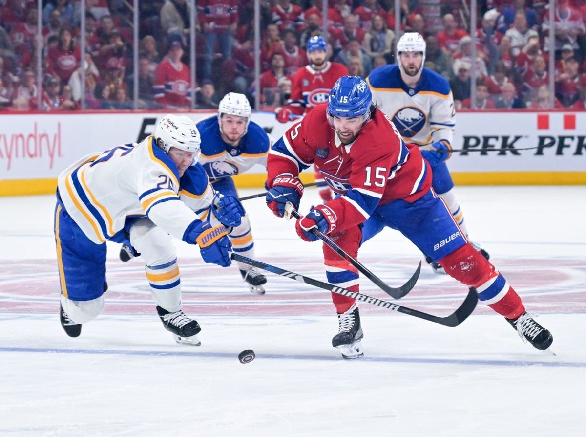 May 10, 2026; Montreal, Quebec, CAN; Montreal Canadiens forward Alex Newhook (15) on his way to score an empty net goal and Buffalo Sabres defenseman Rasmus Dahlin (26) defending during the third period in game three of the second round of the 2026 Stanley Cup Playoffs at the Bell Centre. Mandatory Credit: Eric Bolte-Imagn Images