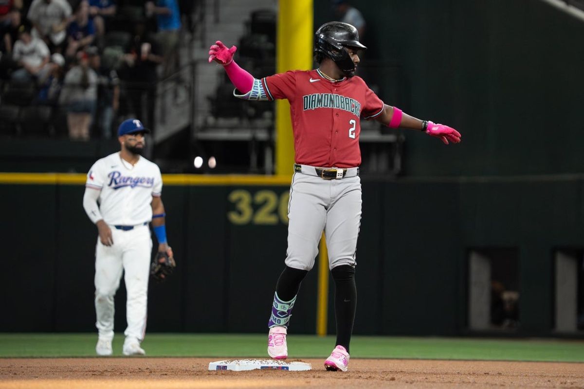 May 11, 2026; Arlington, Texas, USA; Arizona Diamondbacks shortstop Geraldo Perdomo (2) reacts after hitting an RBI double against the Texas Rangers during the first inning at Globe Life Field. Mandatory Credit: Raymond Carlin III-Imagn Images