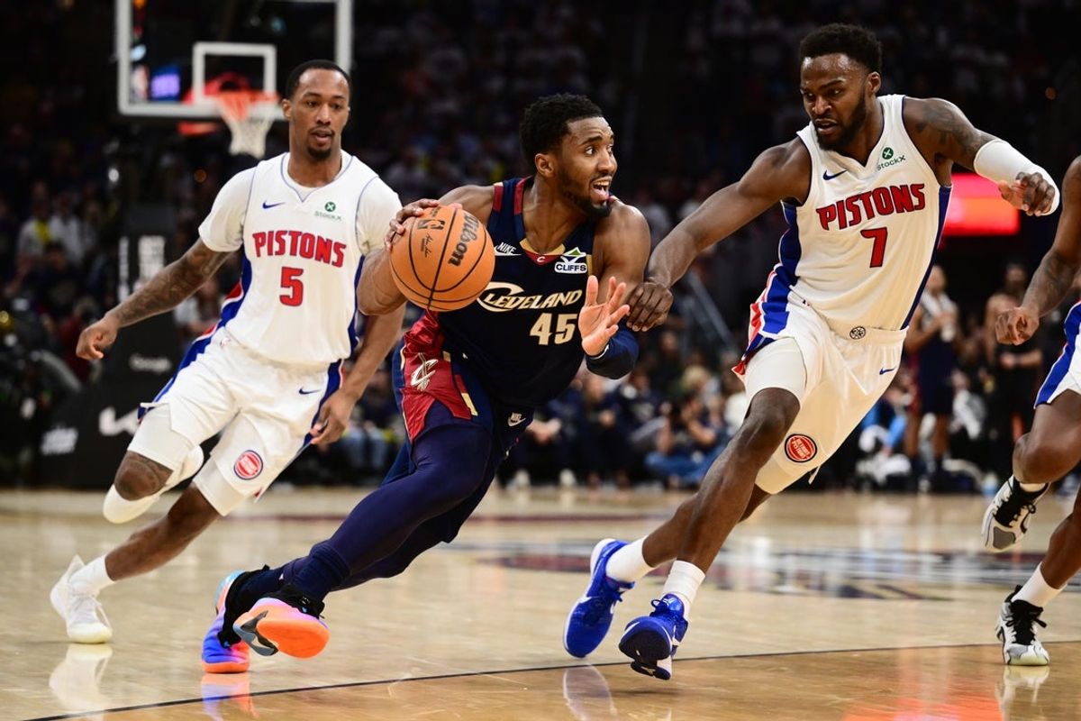 May 11, 2026; Cleveland, Ohio, USA; Cleveland Cavaliers guard Donovan Mitchell (45) drives to the basket against Detroit Pistons forward Paul Reed (7) and forward Ronald Holland II (5) during the second half of game four in the second round of the 2026 NBA Playoffs at Rocket Arena. Mandatory Credit: Ken Blaze-Imagn Images