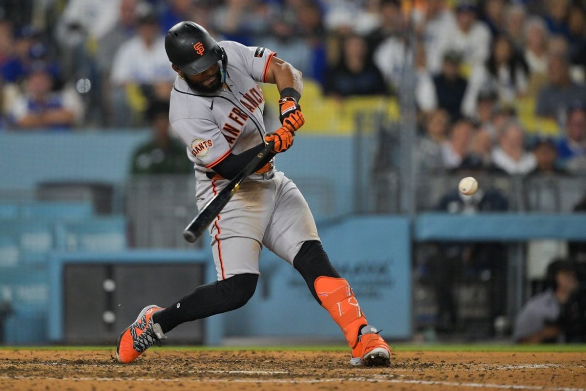 May 11, 2026; Los Angeles, California, USA; San Francisco Giants left fielder Heliot Ramos (17) doubles in two runs in the sixth inning against the Los Angeles Dodgers at Dodger Stadium. Mandatory Credit: Jayne Kamin-Oncea-Imagn Images