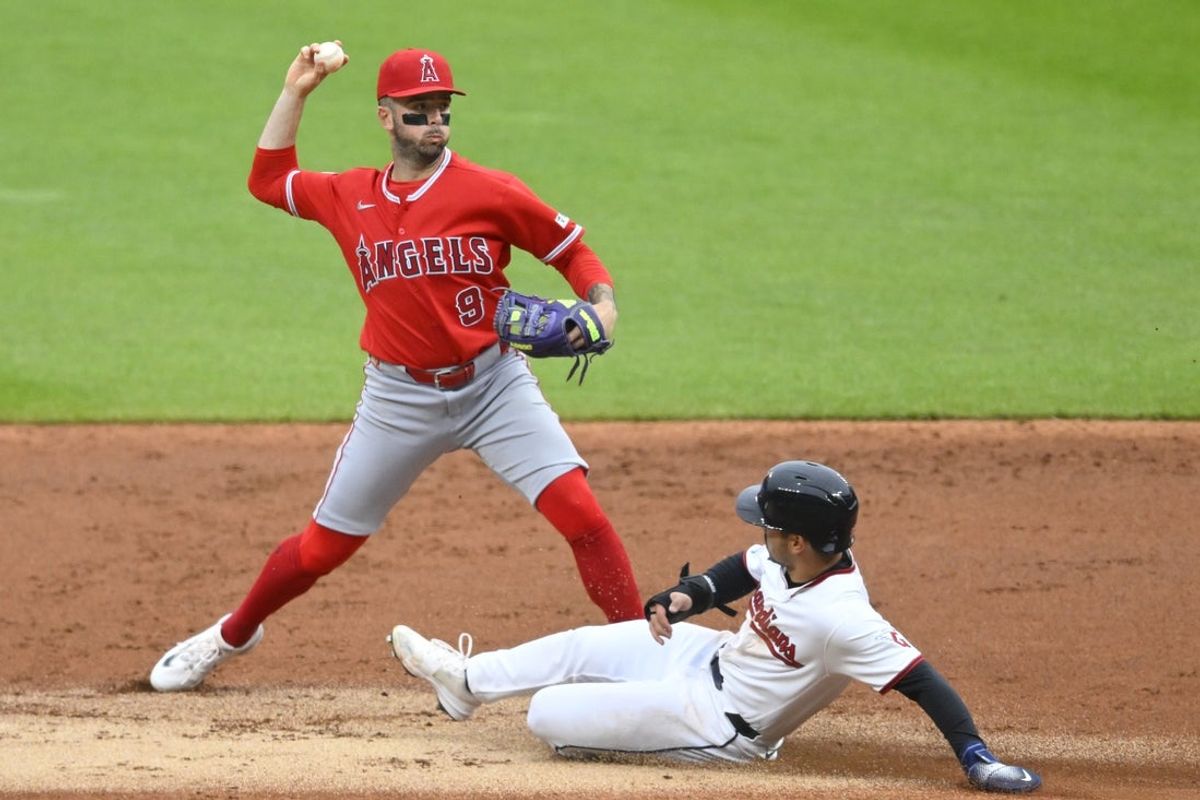 May 12, 2026; Cleveland, Ohio, USA; Los Angeles Angels shortstop Zach Neto (9) turns a double play beside Cleveland Guardians left fielder Steven Kwan (38) in the first inning at Progressive Field. Mandatory Credit: David Richard-Imagn Images
