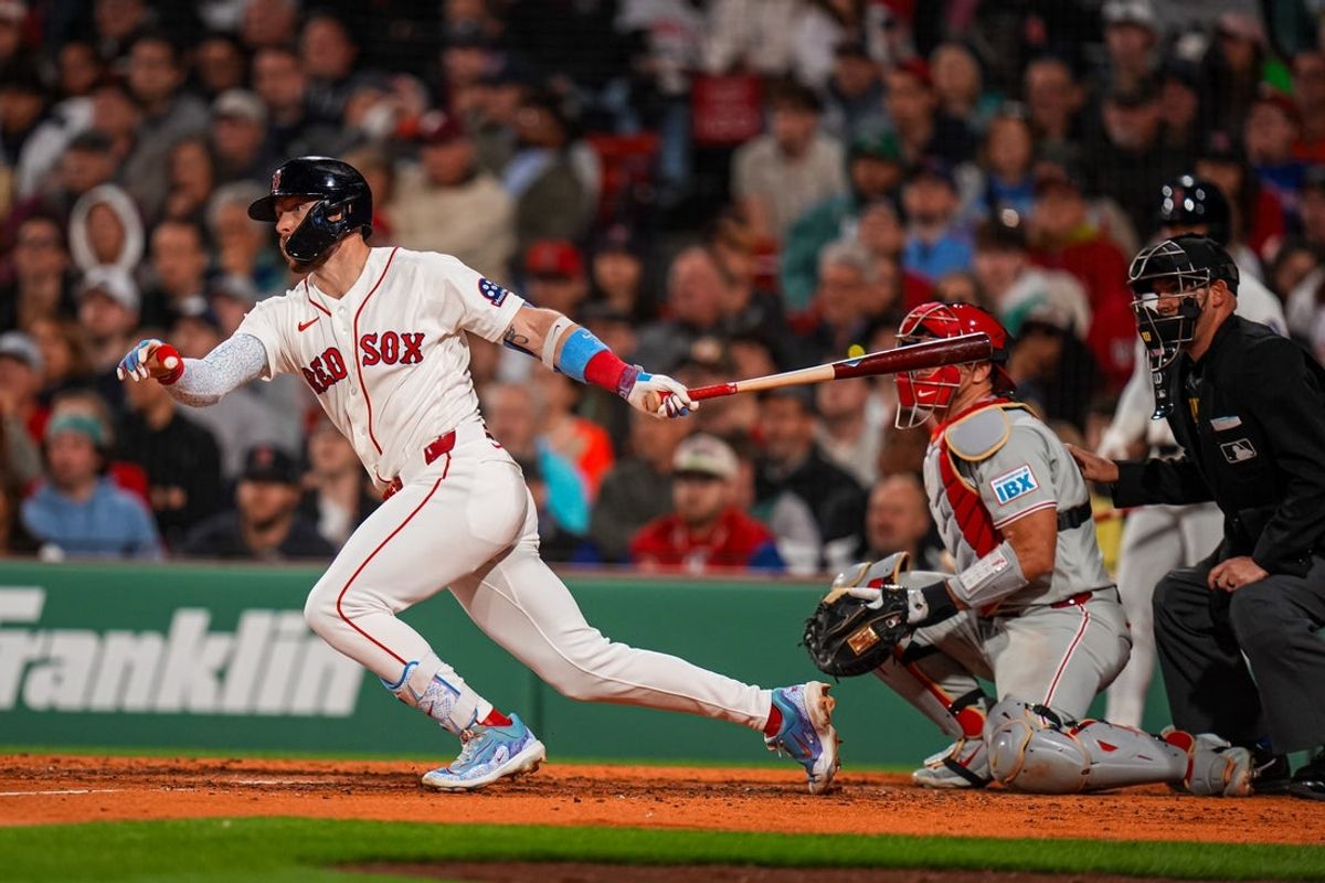 May 12, 2026; Boston, Massachusetts, USA; Boston Red Sox shortstop Trevor Story (10) hits a single against the Philadelphia Phillies in the seventh inning at Fenway Park. Mandatory Credit: David Butler II-Imagn Images