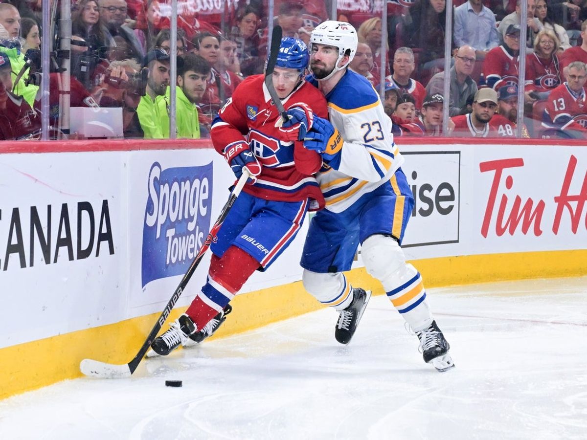 May 12, 2026; Montreal, Quebec, CAN; Montreal Canadiens defenseman Lane Hutson (48) plays the puck and Buffalo Sabres defenseman Mattias Samuelsson (23) defends during the third period in game four of the second round of the 2026 Stanley Cup Playoffs at Bell Centre. Mandatory Credit: Eric Bolte-Imagn Images