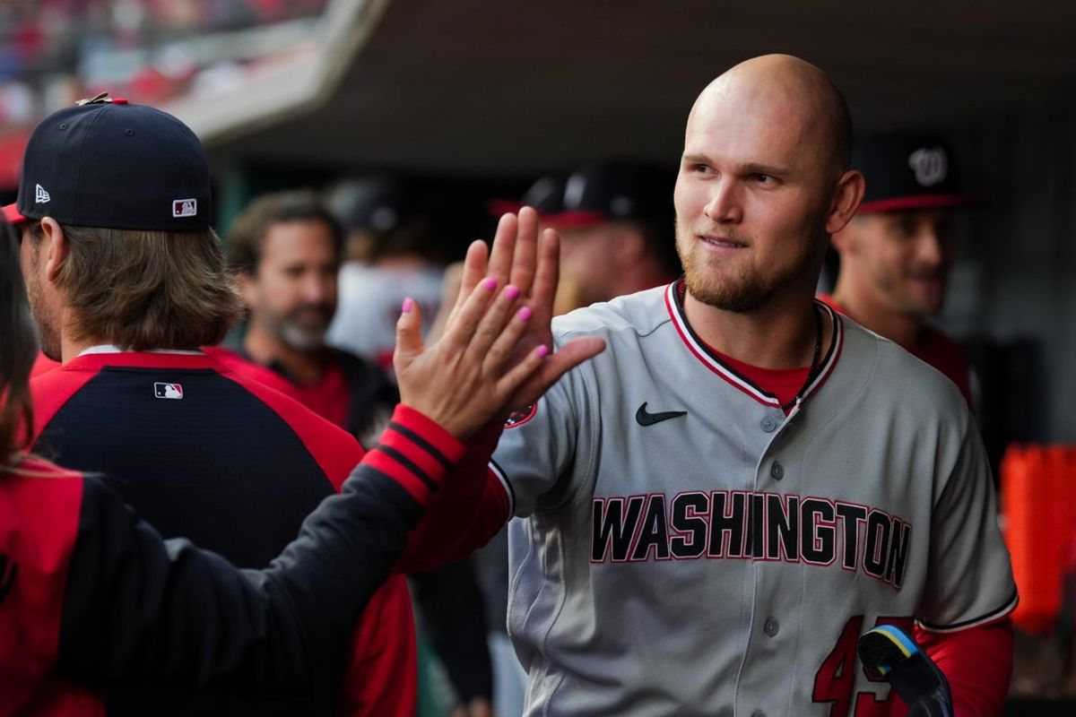 May 13, 2026; Cincinnati, Ohio, USA;  Washington Nationals first baseman Curtis Mead (45) high-fives teammates after scoring a run against the Cincinnati Reds in the third inning at Great American Ball Park. Mandatory Credit: Aaron Doster-Imagn Images