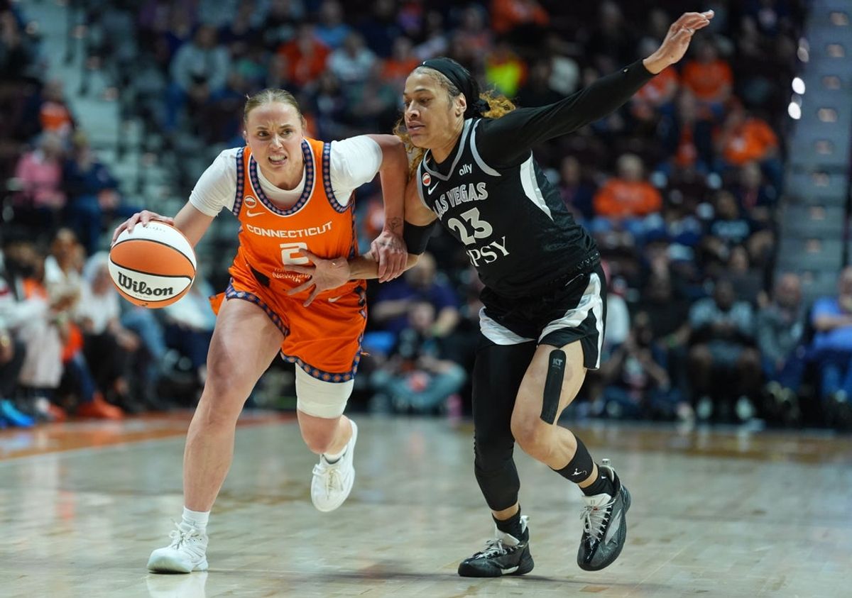 May 13, 2026; Uncasville, Connecticut, USA; Connecticut Sun guard Hailey van Lith (2) drives the ball against Las Vegas Aces guard Chennedy Carter (23) in the first half at Mohegan Sun Arena. Mandatory Credit: David Butler II-Imagn Images