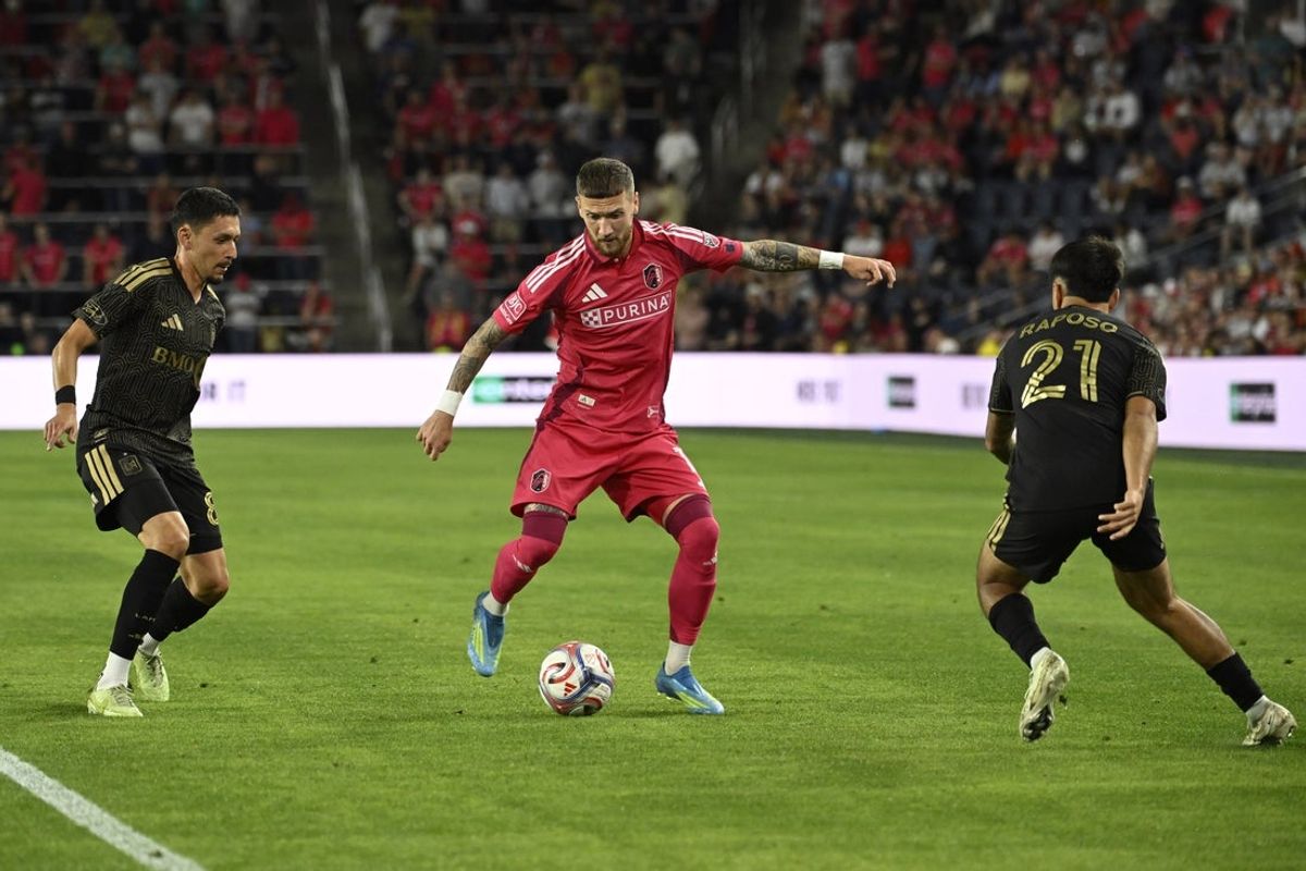 May 13, 2026; St. Louis, Missouri, USA; Los Angeles Football Club midfielder Mark Delgado (8) and midfielder Ryan Raposo (21) defend against St. Louis CITY SC midfielder Marcel Hartel (17) in the second half at Energizer Park. Mandatory Credit: Joe Puetz-Imagn Images