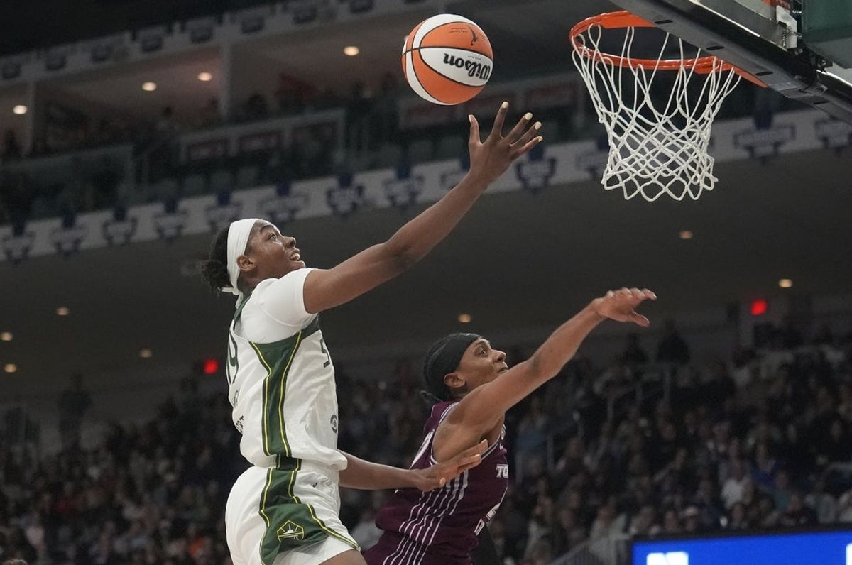 May 13, 2026; Toronto, Ontario, CAN;  Seattle Storm center Dominique Malonga (14) goes up to make a basket against Toronto Tempo guard Brittney Sykes (20) during the first half at Coca-Cola Coliseum. Mandatory Credit: John E. Sokolowski-Imagn Images