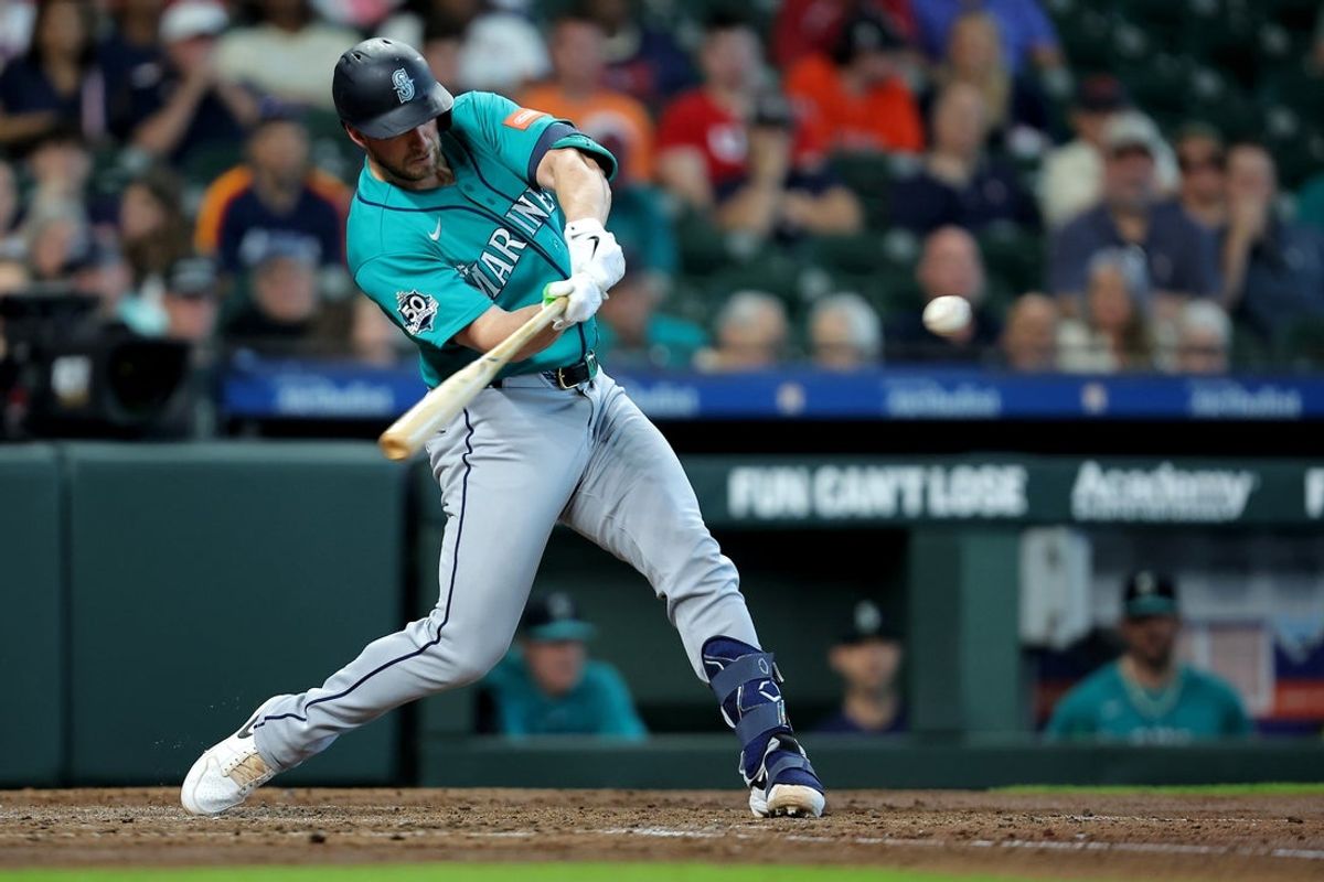 May 14, 2026; Houston, Texas, USA; Seattle Mariners catcher Mitch Garver (18) hits a two-run home run against the Houston Astros during the fourth inning at Daikin Park. Mandatory Credit: Erik Williams-Imagn Images