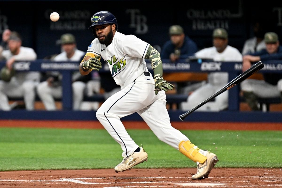 May 15, 2026; St. Petersburg, Florida, USA; Tampa Bay Rays center fielder Cedric Mullins (31) bunts for single in the second  inning against the Miami Marlins at Tropicana Field. Mandatory Credit: Jonathan Dyer-Imagn Images