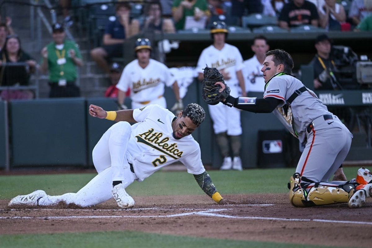 May 15, 2026; West Sacramento, California, USA; Athletics third baseman Darell Hernaiz (2) is tagged out by San Francisco Giants catcher Daniel Susan (6) at home plate during the second inning at Sutter Health Park. Mandatory Credit: Ed Szczepanski-Imagn Images