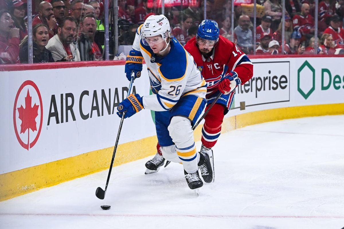 May 16, 2026; Montreal, Quebec, CAN; Buffalo Sabres defenseman Rasmus Dahlin (26) defrends the puck against Montreal Canadiens center Nick Suzuki (14) during the third period in game six of the second round of the 2026 Stanley Cup Playoffs at Bell Centre. Mandatory Credit: David Kirouac-Imagn Images