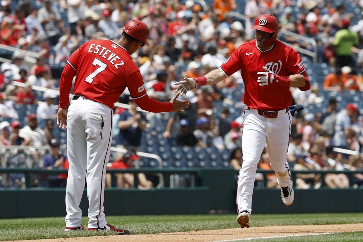 May 17, 2026; Washington, District of Columbia, USA; Washington Nationals center fielder Jacob Young (30) celebrates with Nationals third base coach Victor Estevez (7) while rounding the bases after hitting a solo home run against the Baltimore Orioles during the second inning at Nationals Park. Mandatory Credit: Geoff Burke-Imagn Images