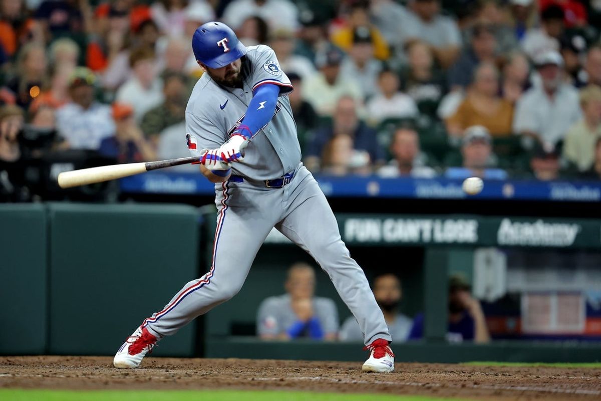 May 17, 2026; Houston, Texas, USA; Texas Rangers first baseman Jake Burger (21) hits a two-run home run to right field against the Houston Astros during the fifth inning at Daikin Park. Mandatory Credit: Erik Williams-Imagn Images