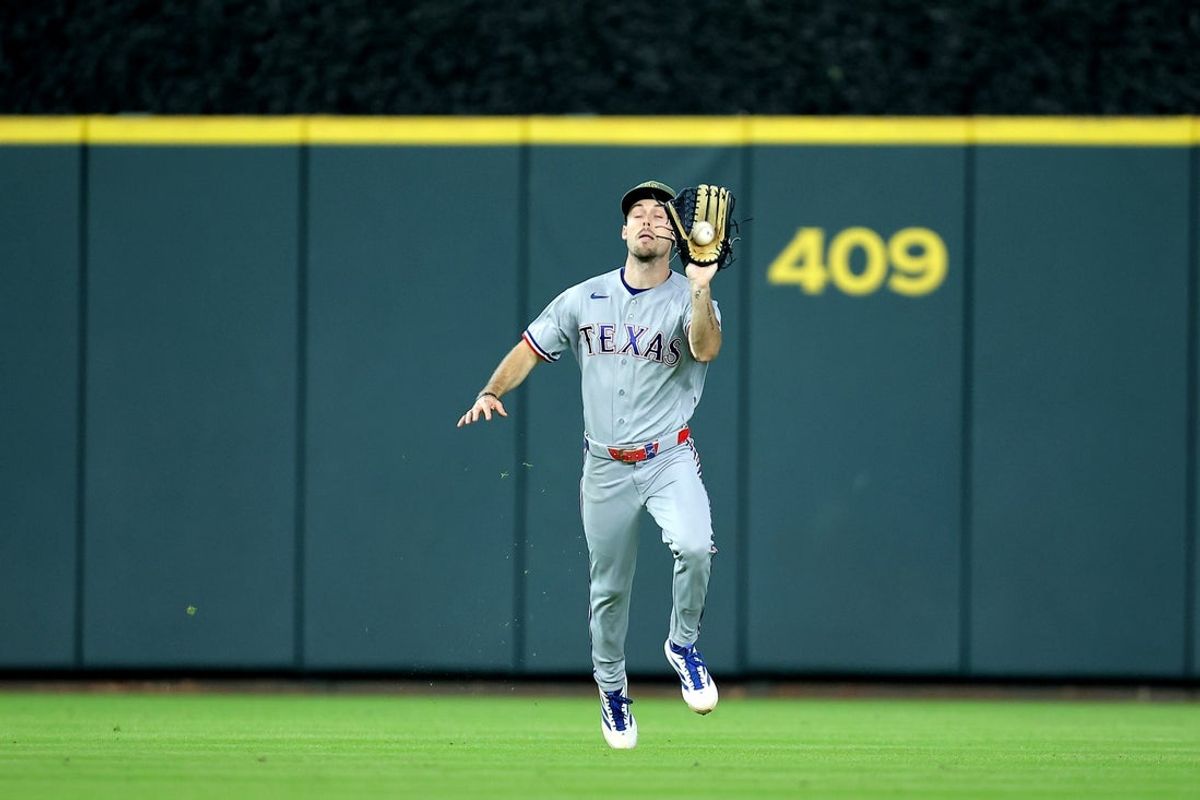 May 17, 2026; Houston, Texas, USA; Texas Rangers center fielder Evan Carter (32) catches a fly ball for an out against the Houston Astros during the eighth inning at Daikin Park. Mandatory Credit: Erik Williams-Imagn Images