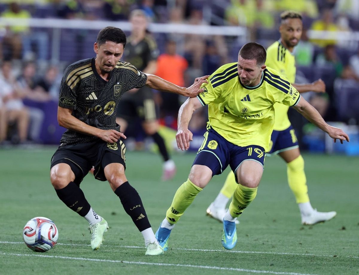 May 17, 2026; Nashville, Tennessee, USA; Los Angeles Football Club midfielder Mark Delgado (8) competes for the ball with Nashville SC midfielder Alex Muyl (19) during the second half at Geodis Park. Mandatory Credit: Alan Poizner-Imagn Images