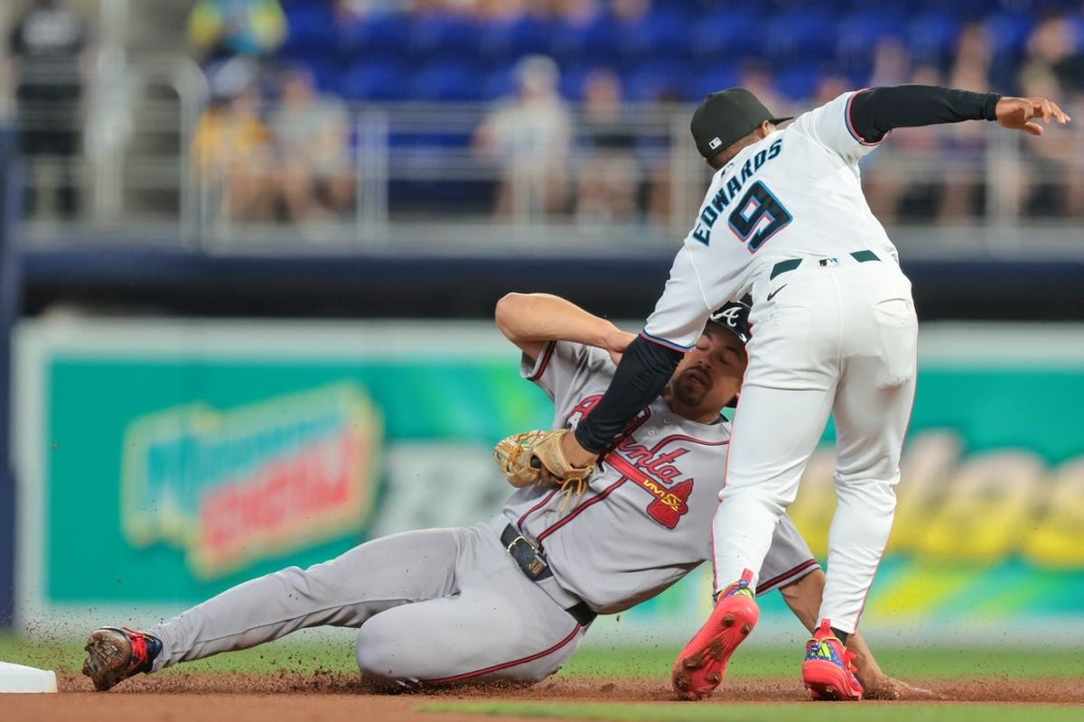 May 18, 2026; Miami, Florida, USA; Miami Marlins second baseman Xavier Edwards (9) tags out Atlanta Braves catcher Drake Baldwin (30) during the first inning at loanDepot Park. Mandatory Credit: Sam Navarro-Imagn Images