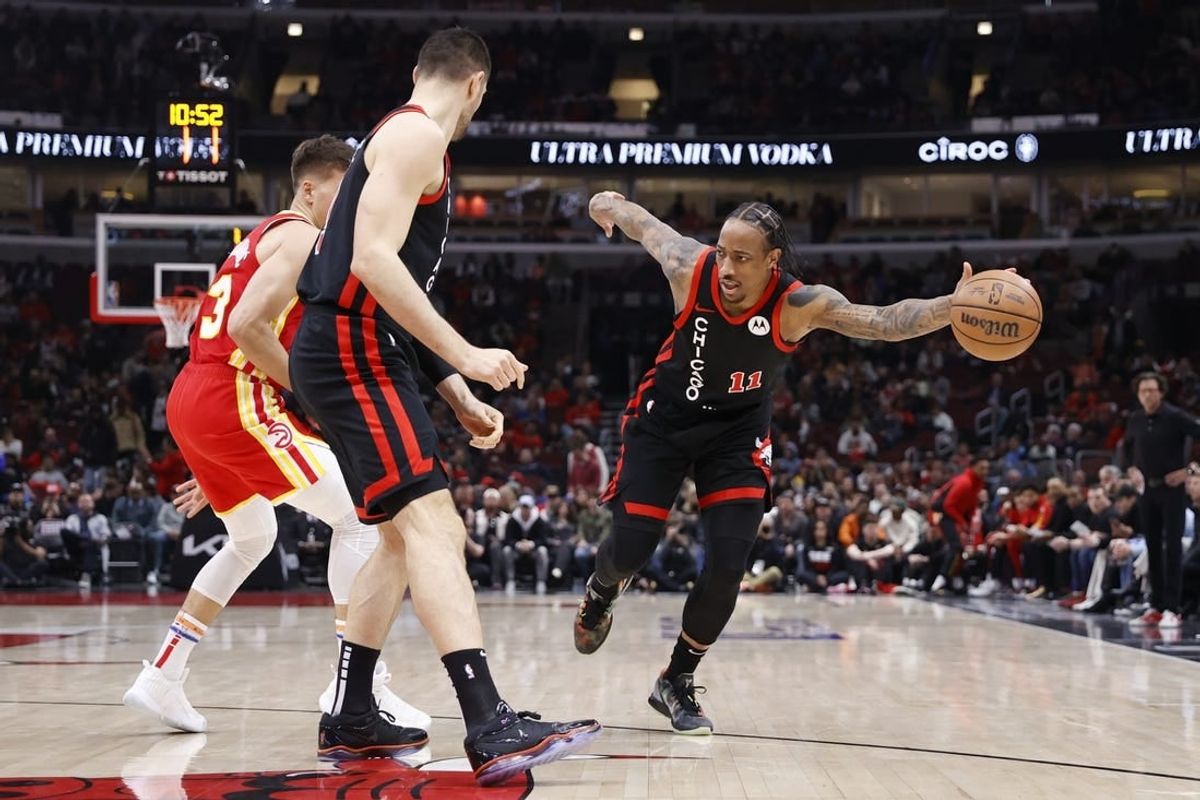 Apr 1, 2024; Chicago, Illinois, USA; Chicago Bulls forward DeMar DeRozan (11) tries to control the ball against the Atlanta Hawks during the first half at United Center.