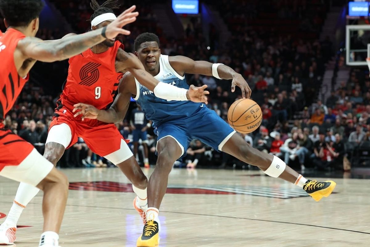 Feb 13, 2024; Portland, Oregon, USA; Minnesota Timberwolves guard Anthony Edwards (5) fights for possession against Portland Trail Blazers forward Jerami Grant (9) in the first quarter at Moda Center.